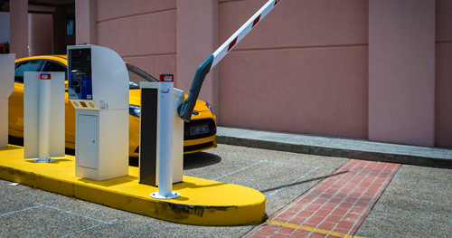 A vehicle exiting a parking space featuring the Automatic Boom Gate with various access control options & installed by TPS.