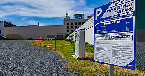 A parking sign with information on car park fees and other important terms and conditions.